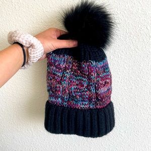 Fleece lined black knit beanie with puff ball